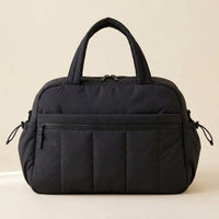 Sac à langer puffer noir sur fond crème